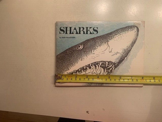 Sharks book by Ann McGovern. 47 pages. Scholastic Book services. Copyright 1976